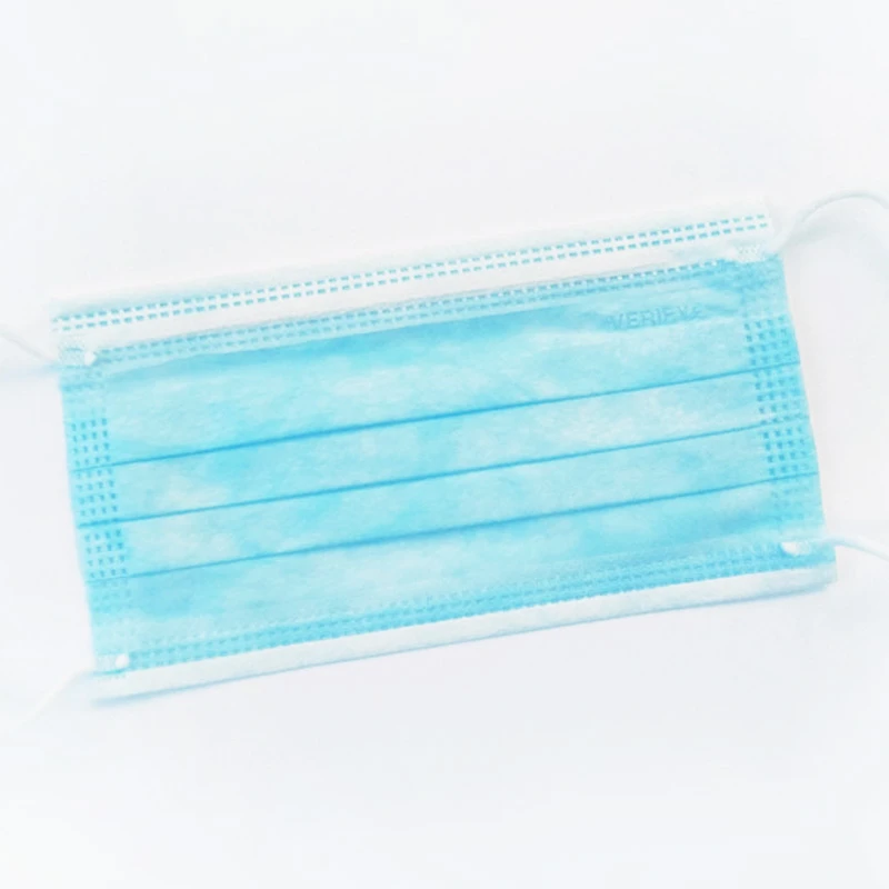 A blue disposable pleated face mask with ear loops on a white background