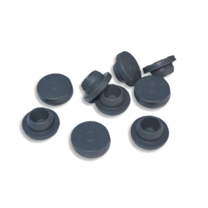 A group of grey butyl rubber self-healing injection ports on a black background