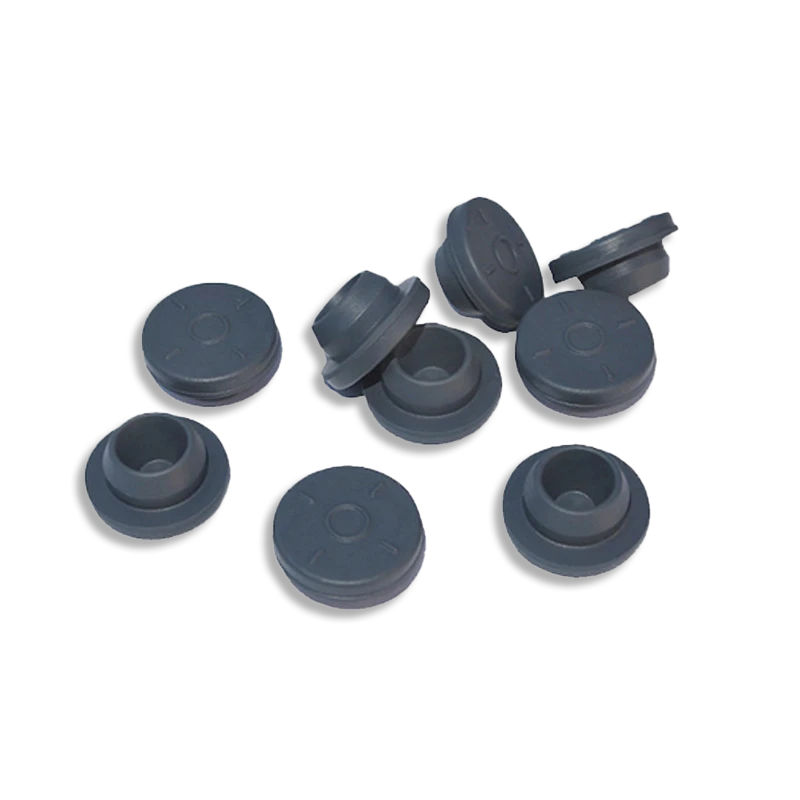 A group of grey butyl rubber self-healing injection ports on a black background