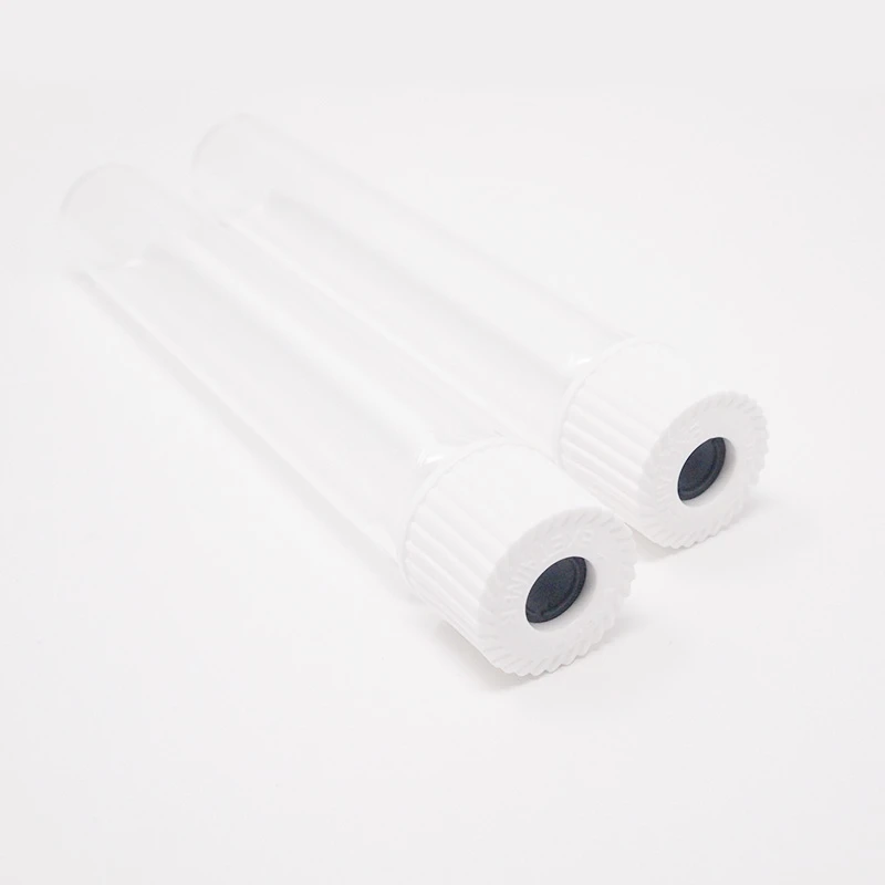Two empty sterile glass vials lying on a white surface, each with a white ribbed cap and a dark rubber injection port