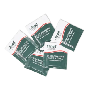 Six sealed Clinell chlorhexidine alcohol wipe sachets arranged on black