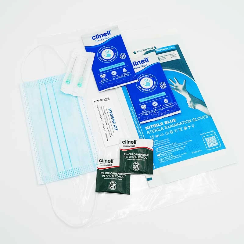 Hygiene kit contents laid out: face mask, nitrile gloves, chlorhexidine wipes and a sterile needle