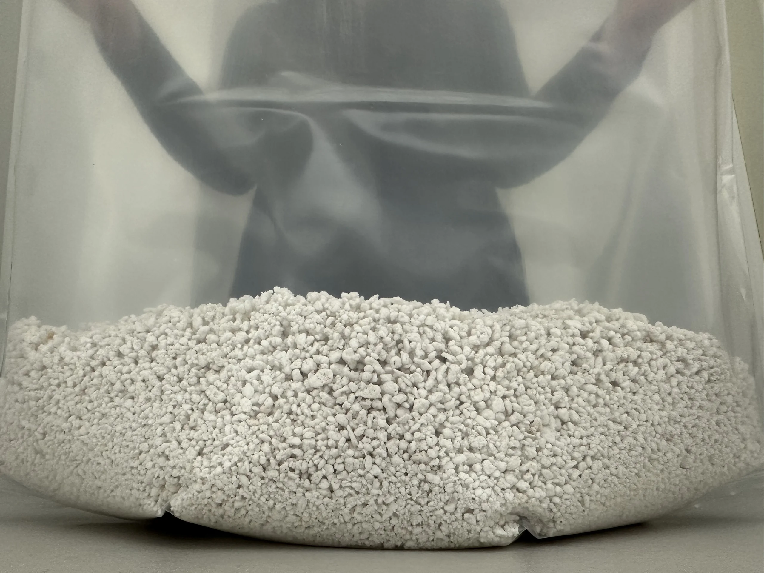 An even bed of hydrated perlite spread across the base of a Cylo Grow Tent, held open from behind