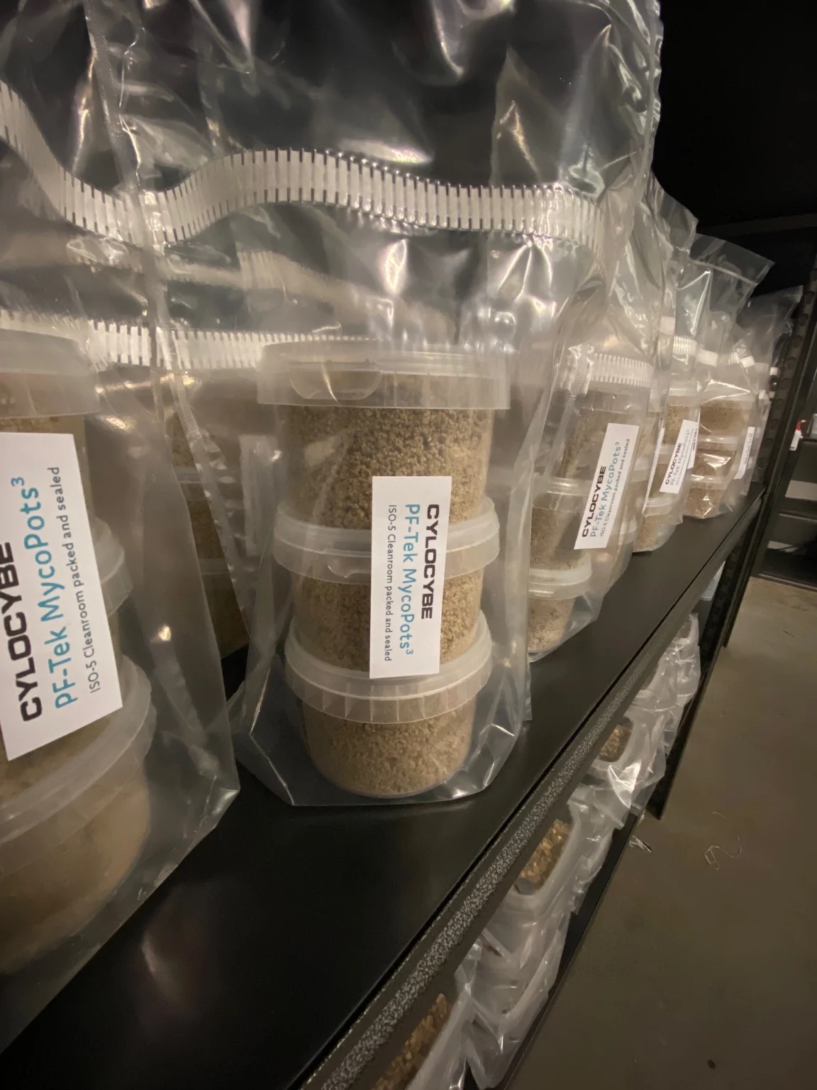 Bagged PF-Tek MycoPots grow kits on a shelf, cleanroom packed and sealed