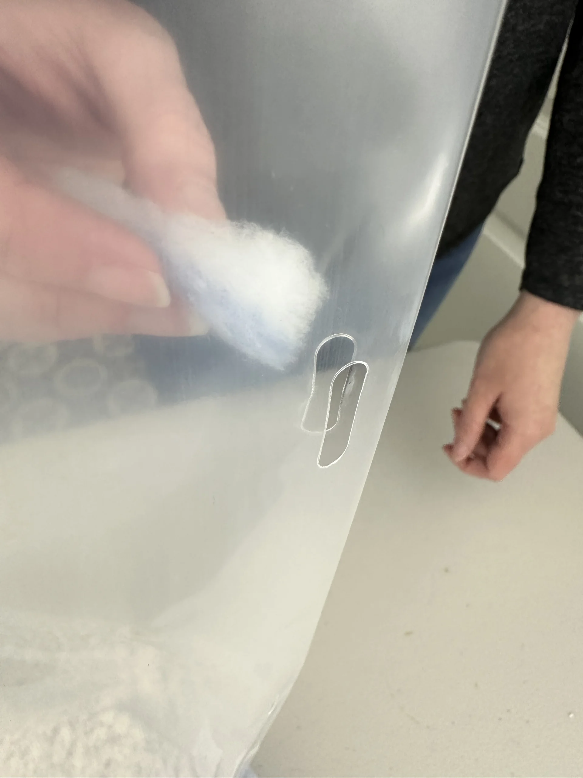 Threading a white filter strip through the laser-cut slits in the side of a Cylo Grow Tent