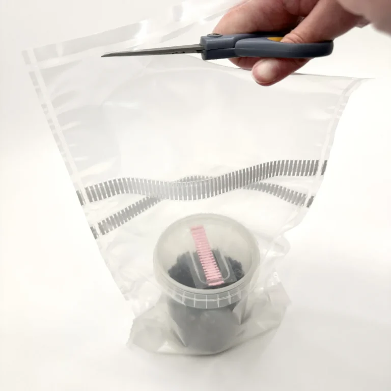 Cutting the top off the WeeZPZ bag, which is kept to use as its grow tent