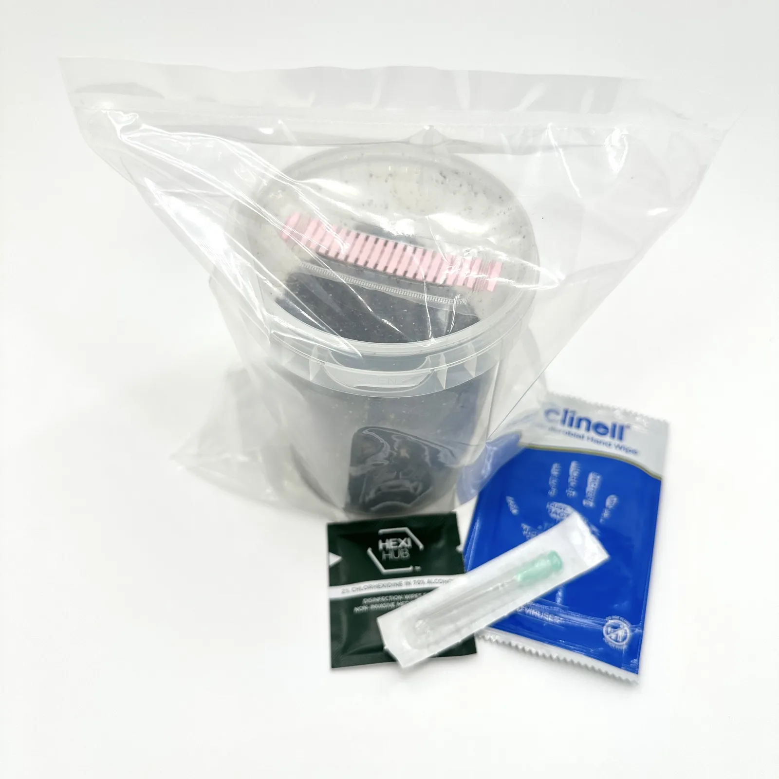 The WeeZPZ substrate cup sealed inside its filter bag, with the sterile needle, chlorhexidine wipe and hand wipe alongside
